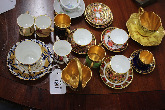 Appraisal: A COLLECTION OF MINIATURE TEA CUPS AND SAUCERS to enclose