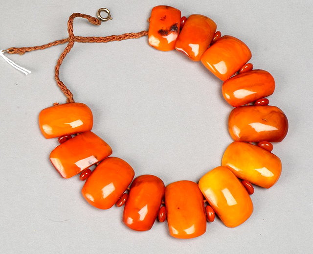 Appraisal: A RECONSTITUTED AMBER BEAD NECKLACE in graduated panel form long