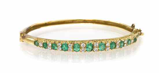 Appraisal: A Karat Yellow Gold Emerald and Diamond Hinged Bangle Bracelet