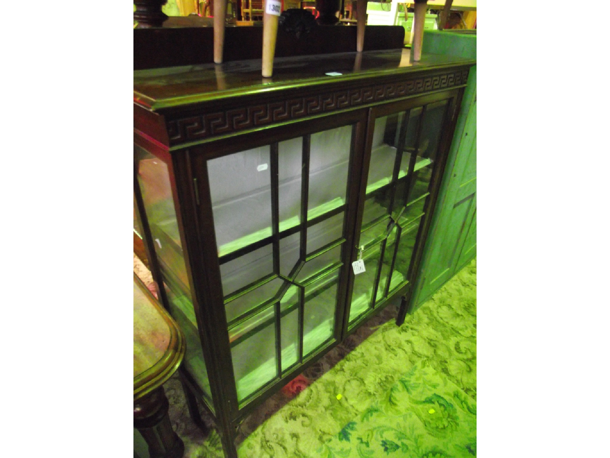 Appraisal: An Edwardian mahogany freestanding display cabinet enclosed by a pair