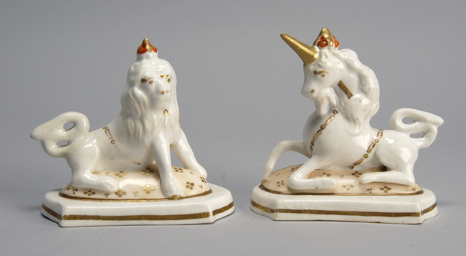 Appraisal: PAIR OF TH CENTURY ENGLISH STAFFORDSHIRE FIGURES a lion and