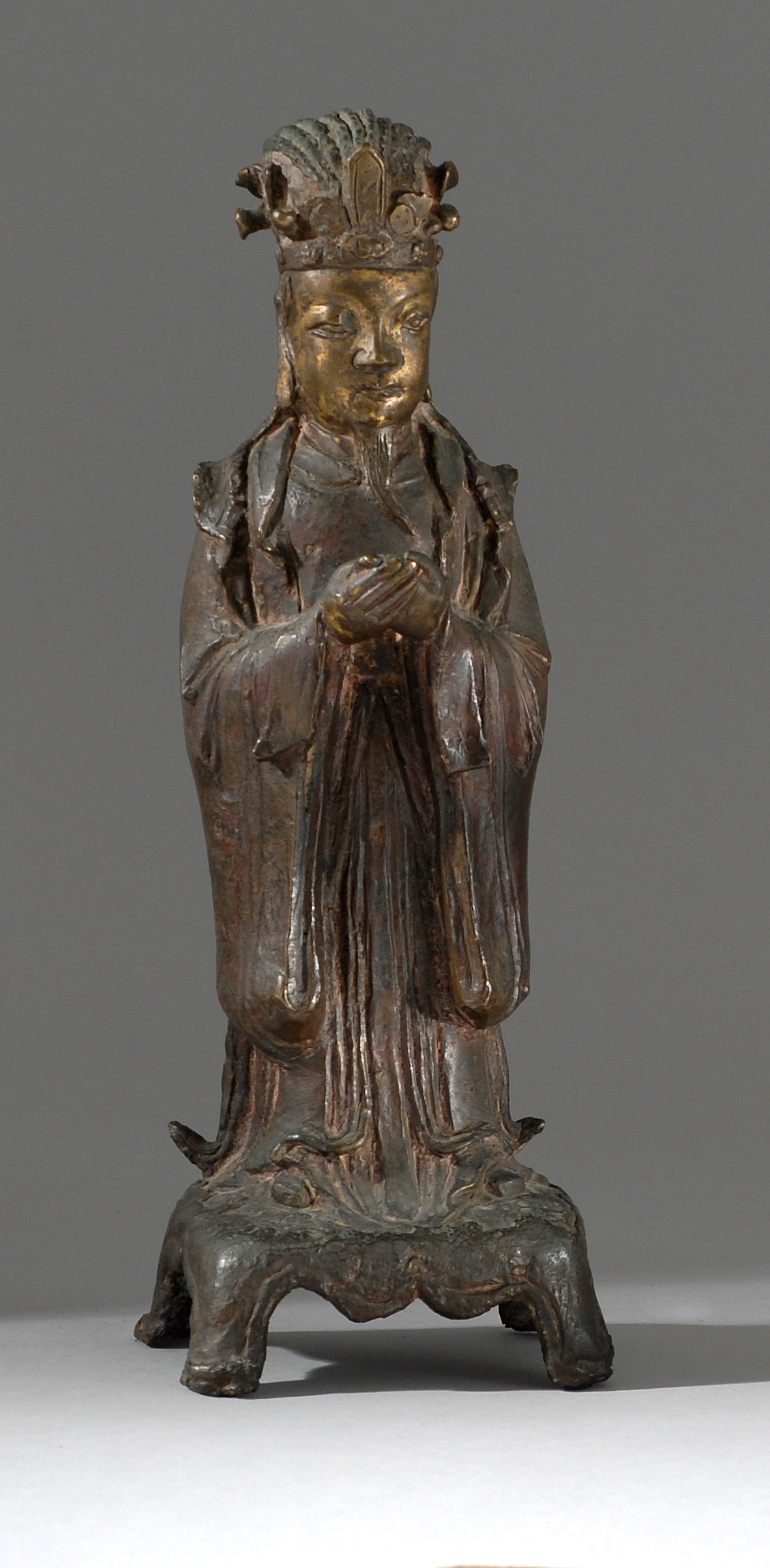 Appraisal: GILT-BRONZE FIGURE OF AN IMMORTAL Ming DynastyStanding on a four-footed