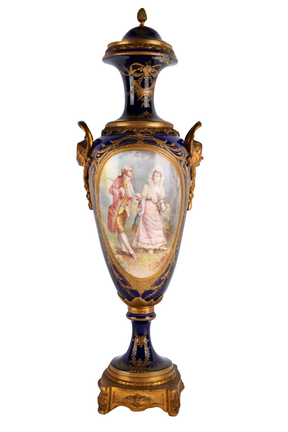 Appraisal: SEVRES-STYLE COBALT PORCELAIN COVERED URNwith gilt metal mounts depicting figures