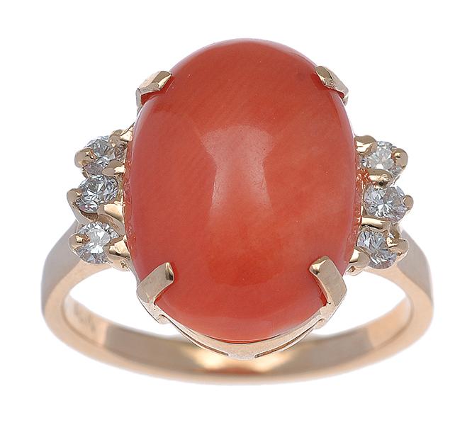 Appraisal: A CORAL AND DIAMOND RING Set with an oval coral