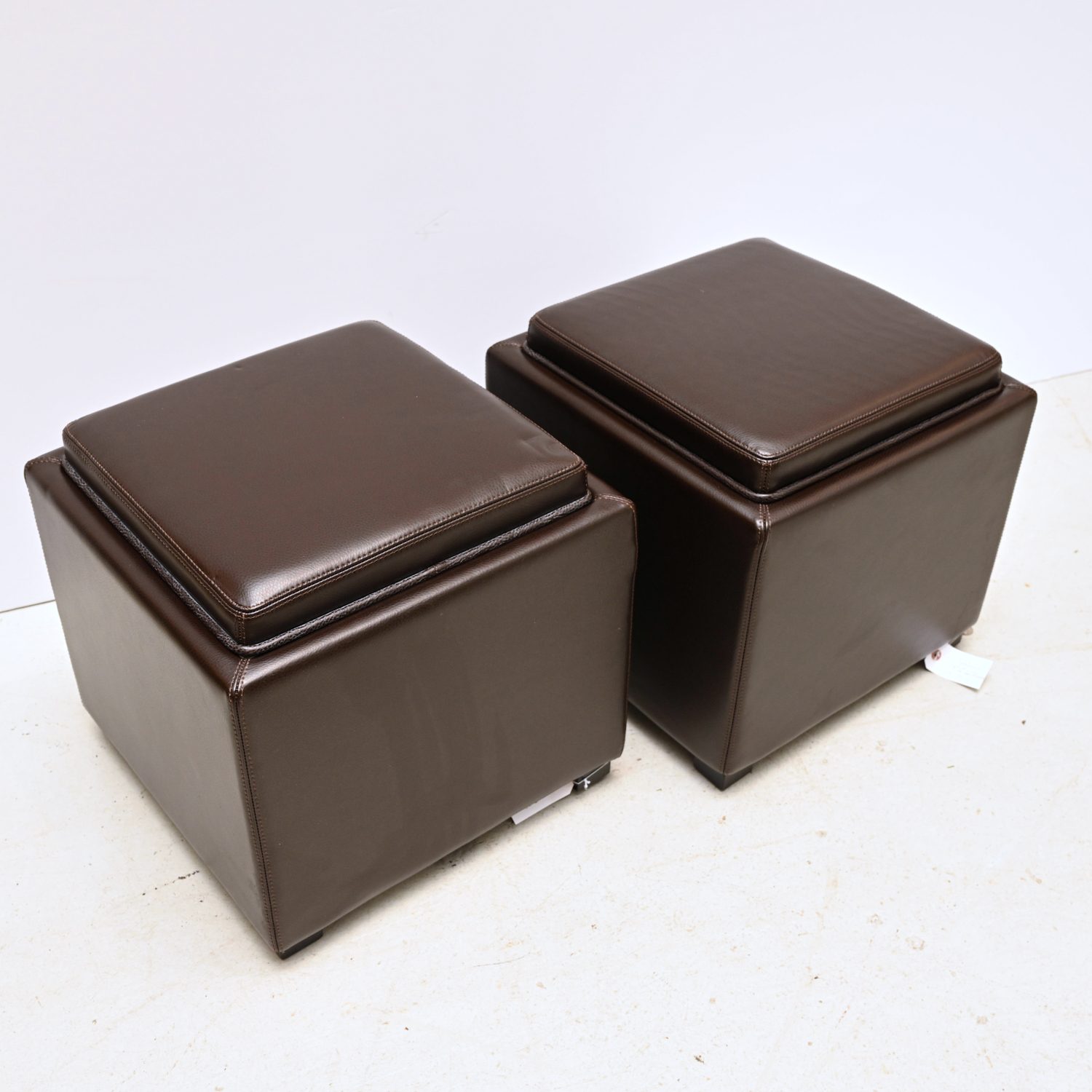 Appraisal: PAIR CRATE BARREL LEATHER STORAGE OTTOMANS st c chocolate brown