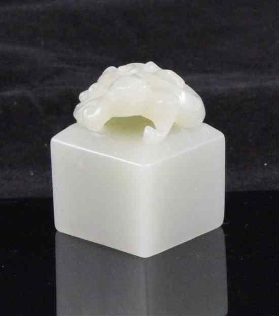 Appraisal: A Chinese celadon jade square seal carved in high relief