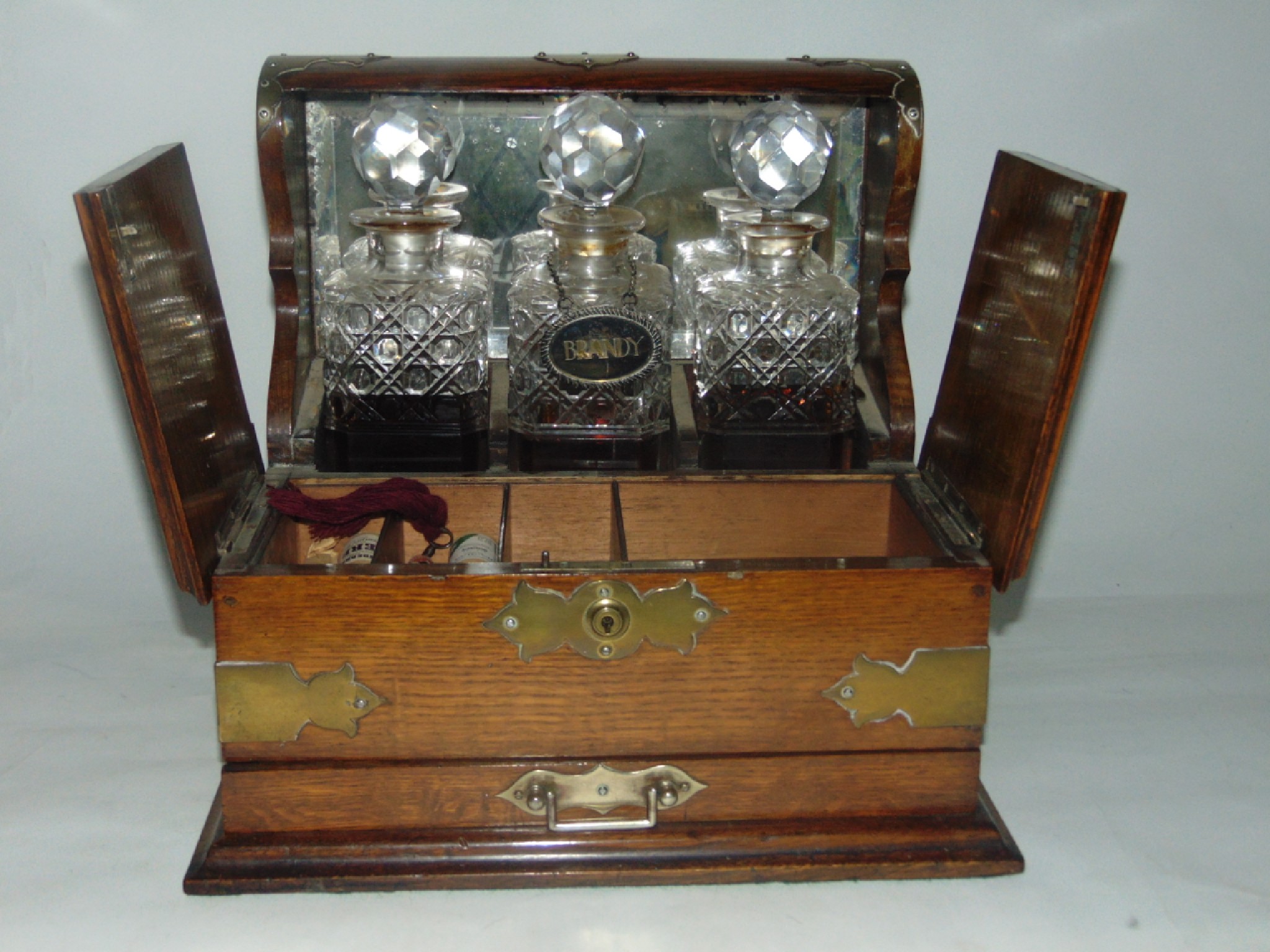 Appraisal: A good quality Victorian desktop tantalus accommodating a trio of