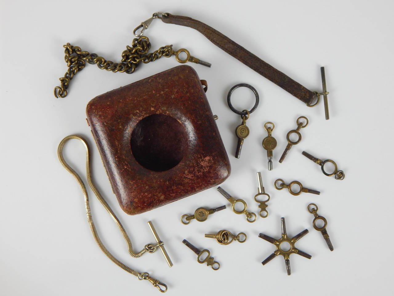 Appraisal: Various pocket watch accessories to include keys and a leather