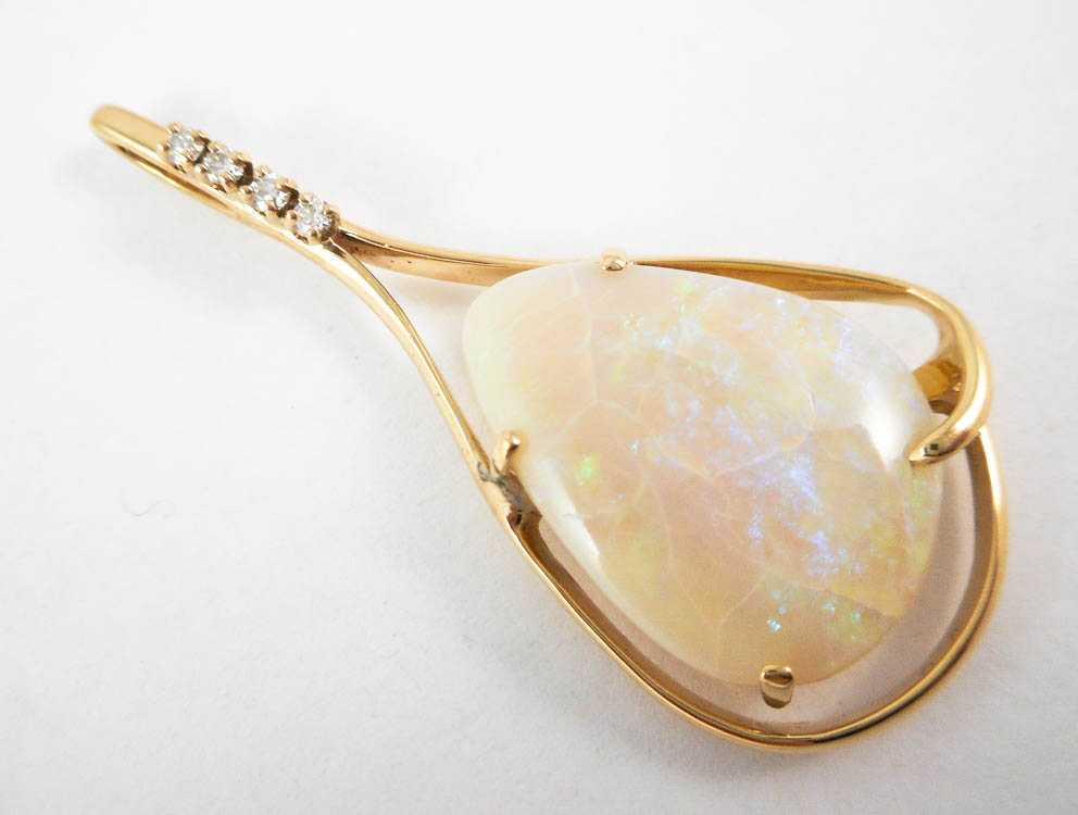 Appraisal: OPAL DIAMOND AND FOURTEEN KARAT GOLD PENDANT with four round-cut