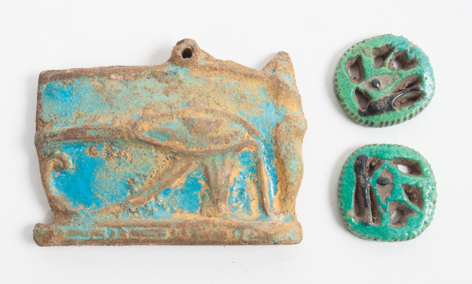 Appraisal: Three ancient Egyptian faience amulets modeled as the Eye of