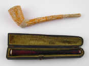 Appraisal: A white metal mounted long cigarette holder with amber mouthpiece