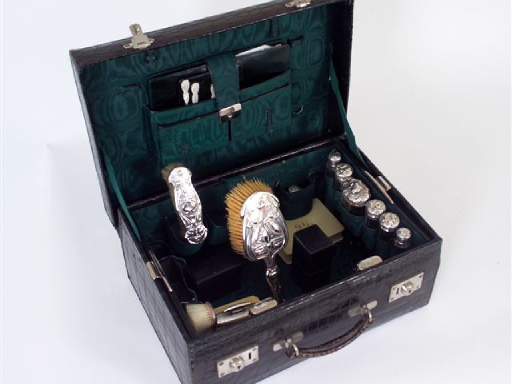 Appraisal: EDWARDIAN TRAVELLING CASE the crocodile case with a silk moire