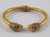 Appraisal: A yellow metal tests carat gold bangle with metal spring