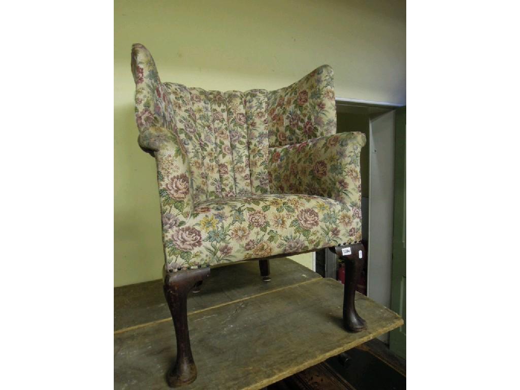 Appraisal: An Edwardian mahogany tub chair with floral upholstered winged and