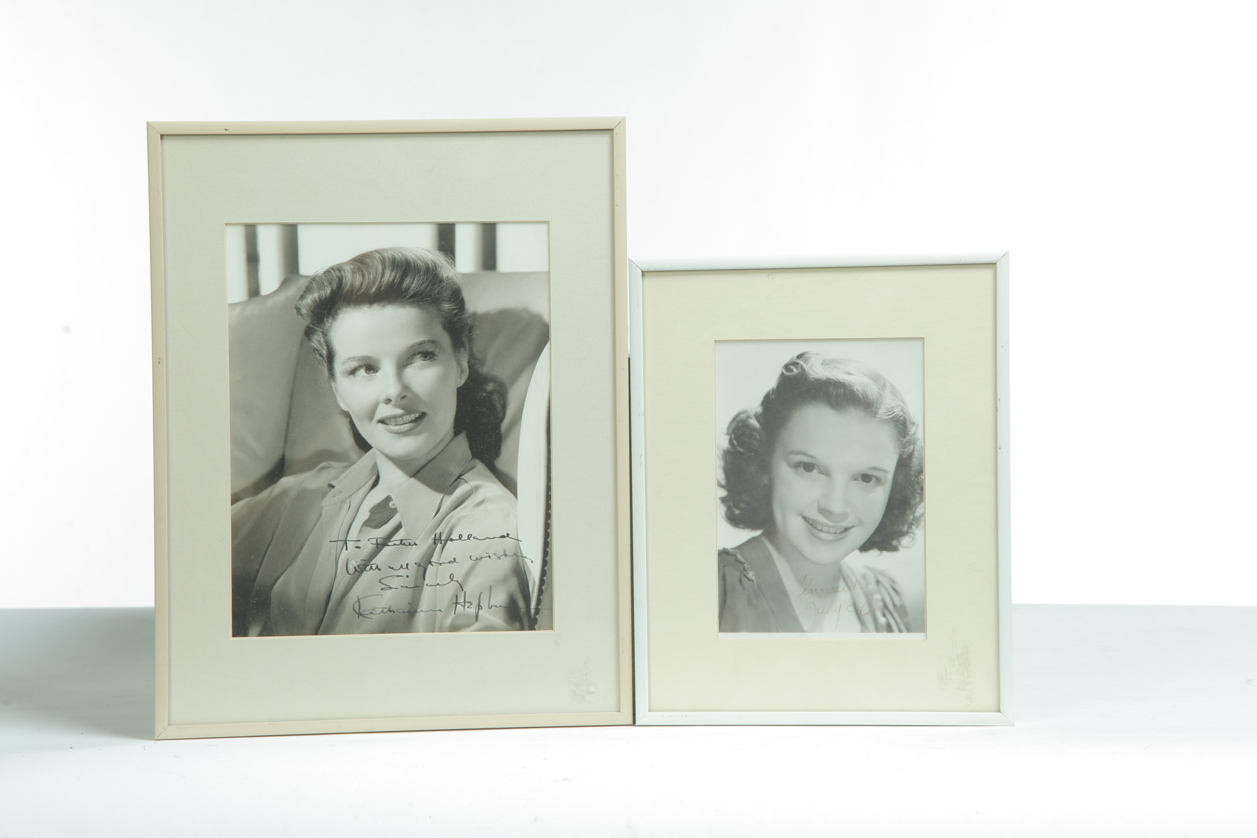 Appraisal: JUDY GARLAND AND KATHERINE HEPBURN SIGNED AND FRAMED PHOTOGRAPHS American