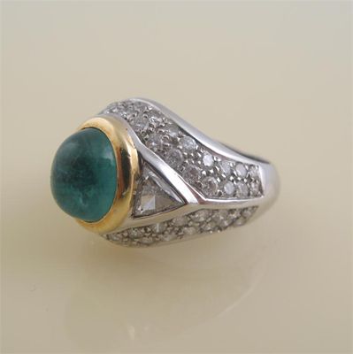 Appraisal: A cabochon emerald and diamond set white gold ring The