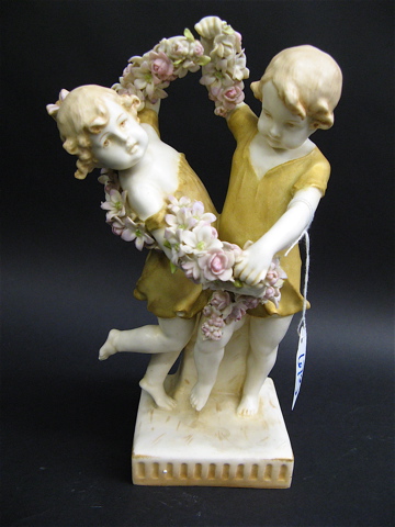 Appraisal: AUSTRIAN PAINTED PORCELAIN FIGURAL GROUP of a young boy and