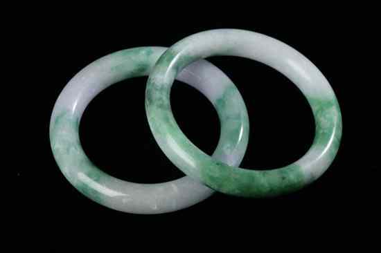 Appraisal: TWO CHINESE GREEN WHITE AND LAVENDER BANGLES - in diam