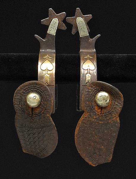 Appraisal: A pair of silver and brass-mounted heart-and-arrow spurs by Kelly