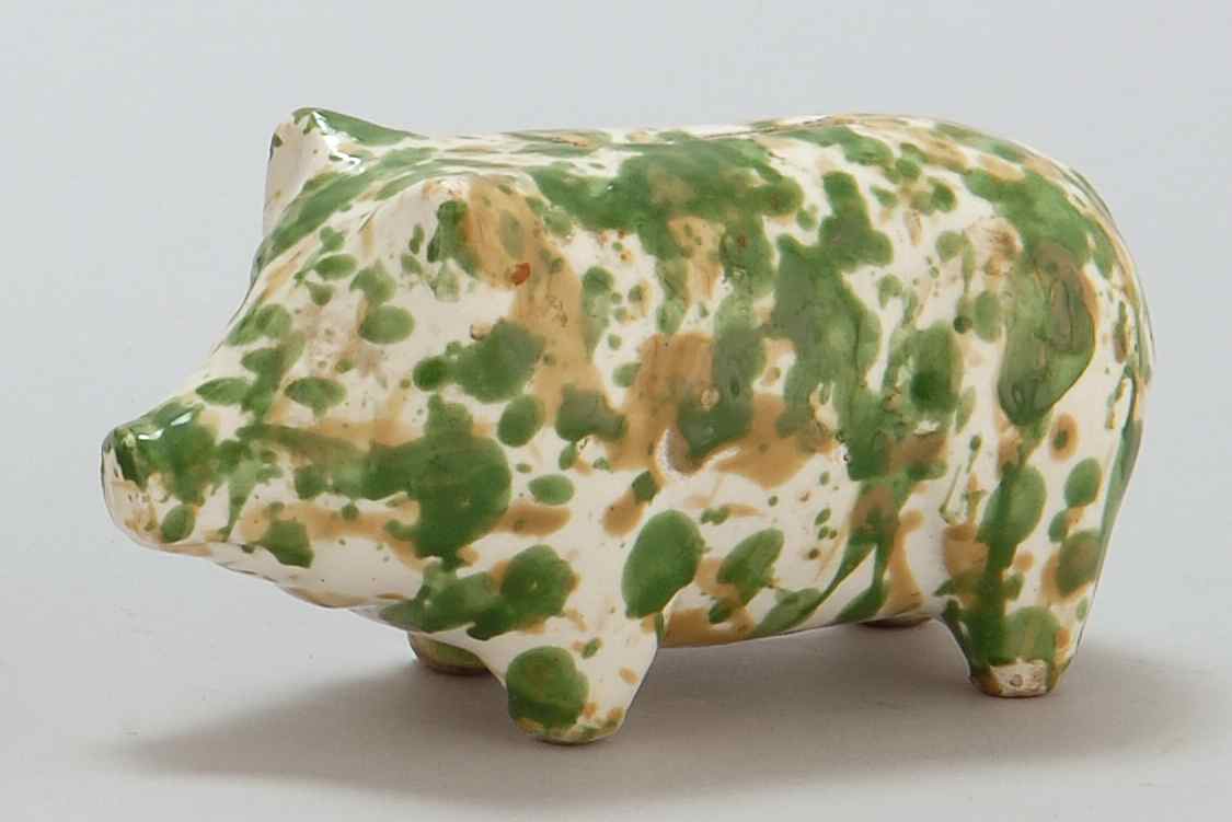 Appraisal: ANTIQUE ENGLISH POTTERY PIG-FORM BANK With green and brown decoration