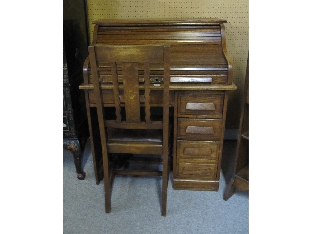 Appraisal: Oak roll top desk with chair