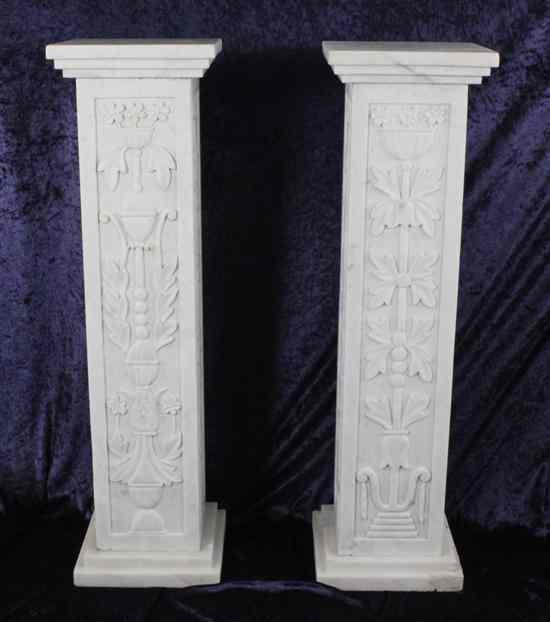 Appraisal: A pair of carved white marble columns decorated with flowers