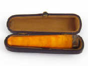 Appraisal: A silver mounted amber cigar holder Chester