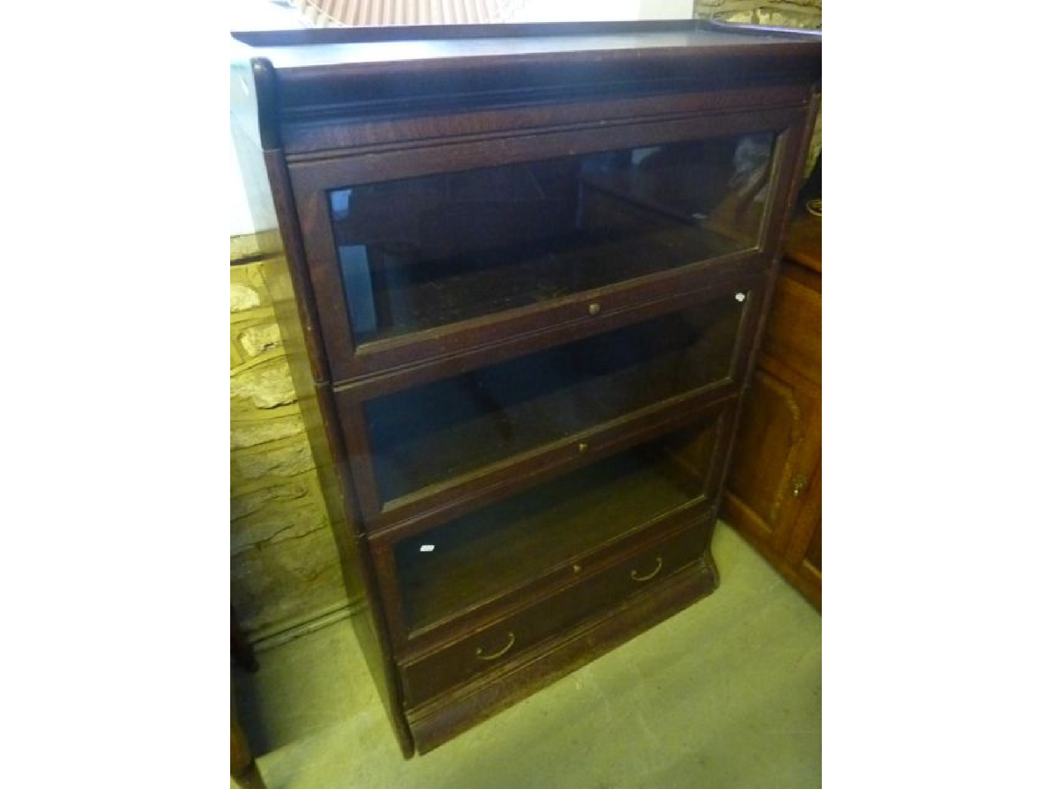 Appraisal: An Edwardian oak floor standing sectional library bookcase probably Globe