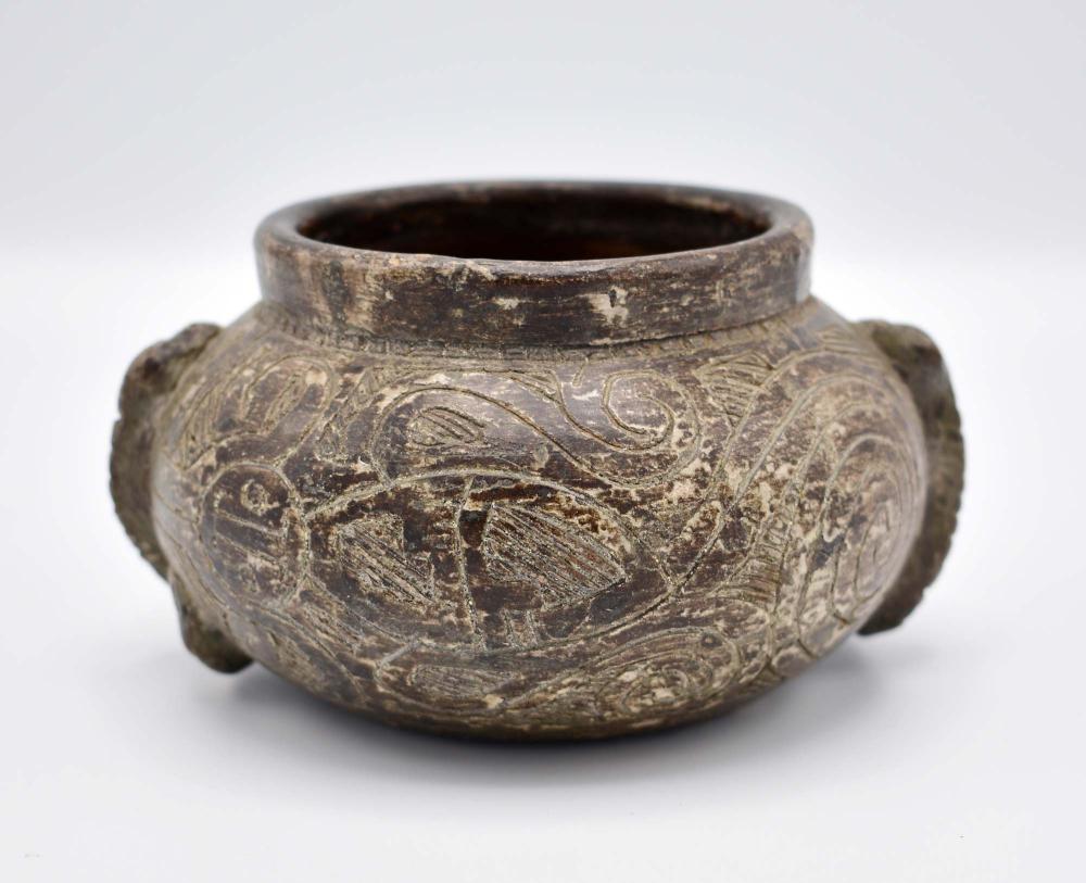 Appraisal: MESOAMERICAN BROWN GLAZED POTTERY BOWLIncised with allover stylized swirls and