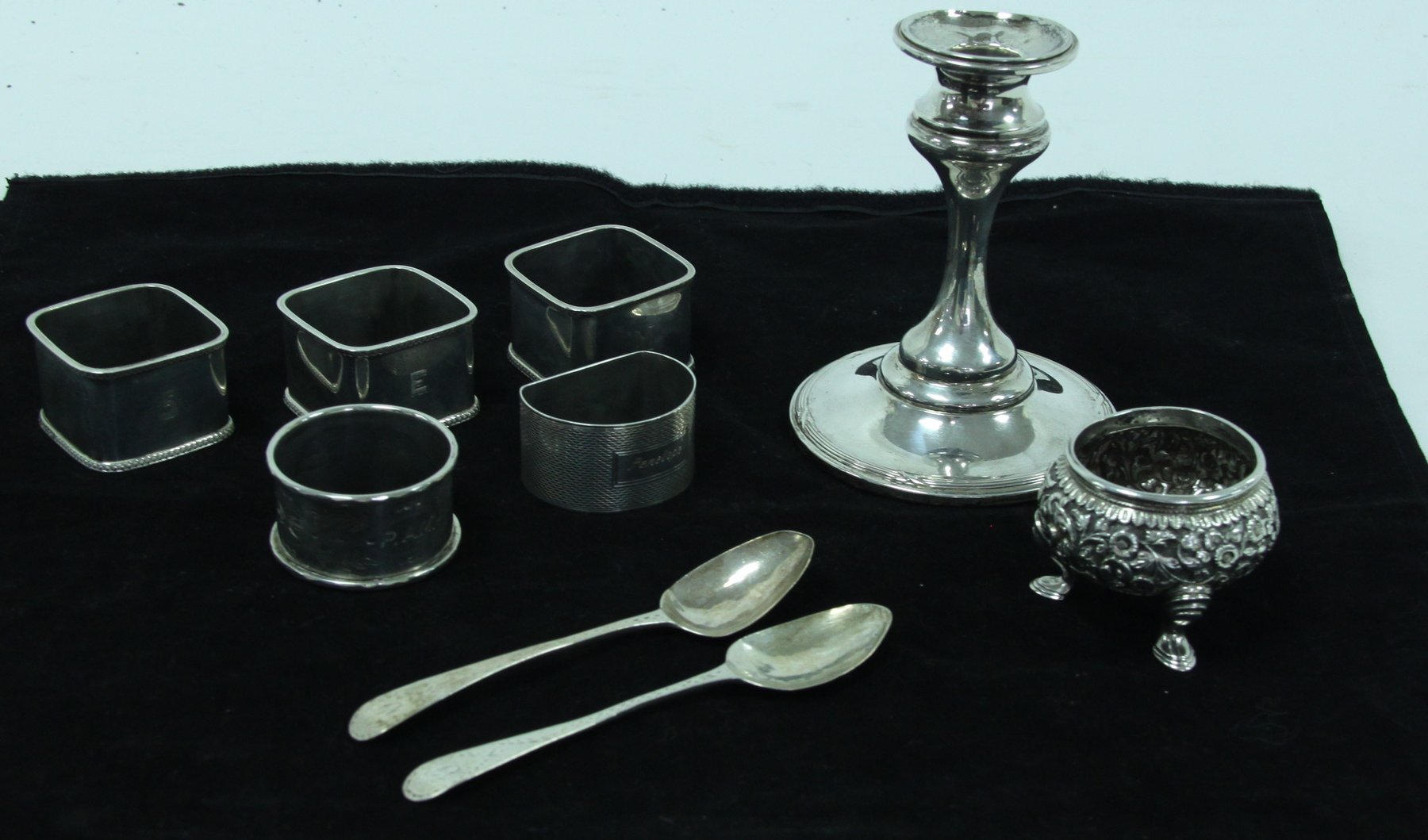 Appraisal: A silver candlestick Birmingham five silver napkin rings two bright