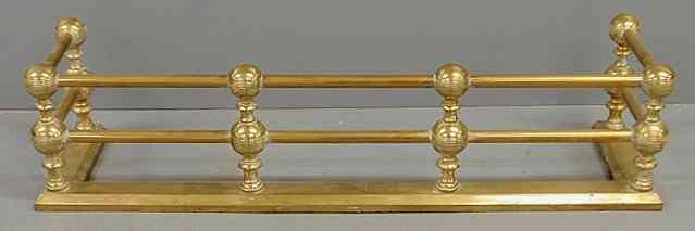 Appraisal: Victorian brass fire fender late th c with turned ball