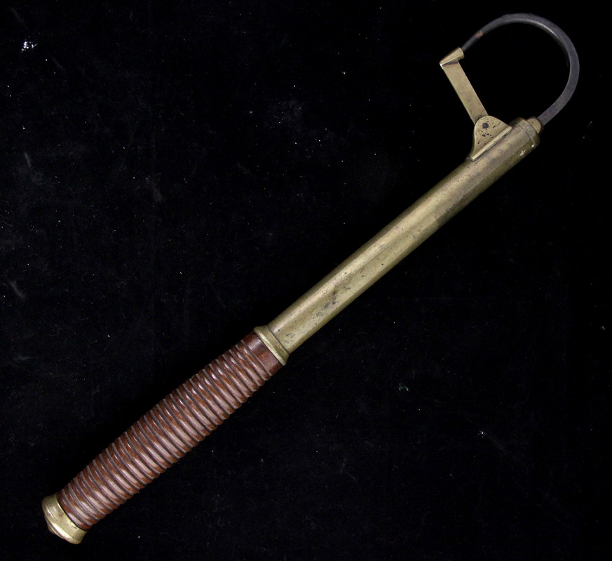 Appraisal: A brass and steel gaff with turned wood handle