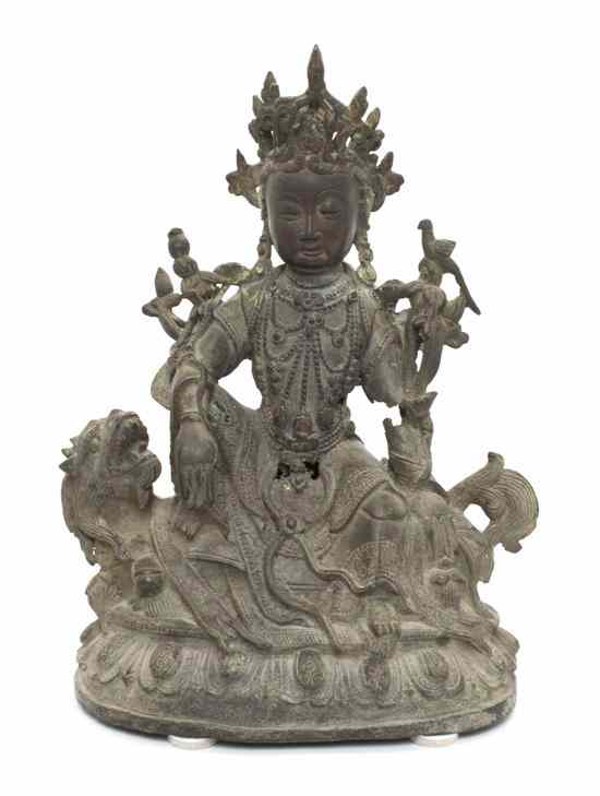 Appraisal: A Chinese Bronze Figure of Guanyin the figure depicted wearing