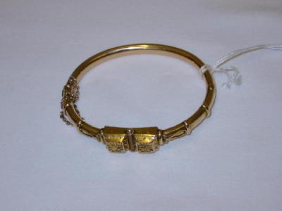 Appraisal: A VICTORIAN GOLD BANGLE the embossed oblong centre with hairwork