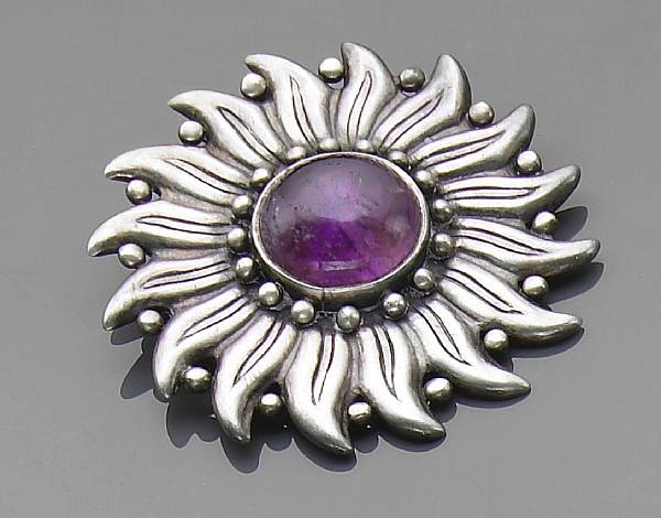 Appraisal: A silver and amethyst brooch in a flowerhead motif signed