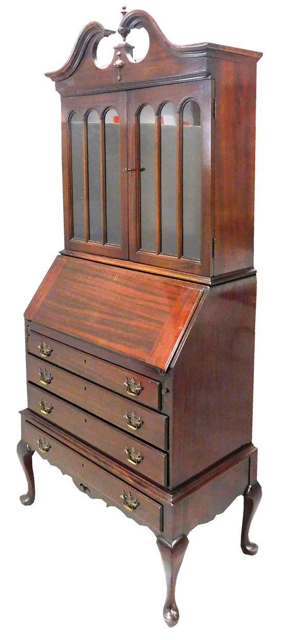 Appraisal: th C two-piece bookcase desk mahogany top with scrolled crest