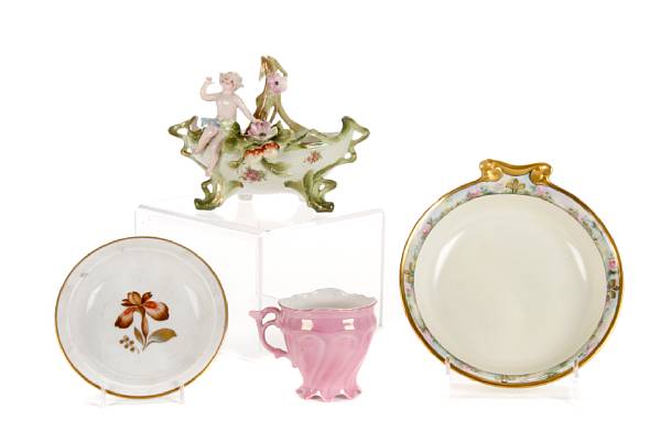 Appraisal: A group of porcelain table articles comprising a cabinet cup