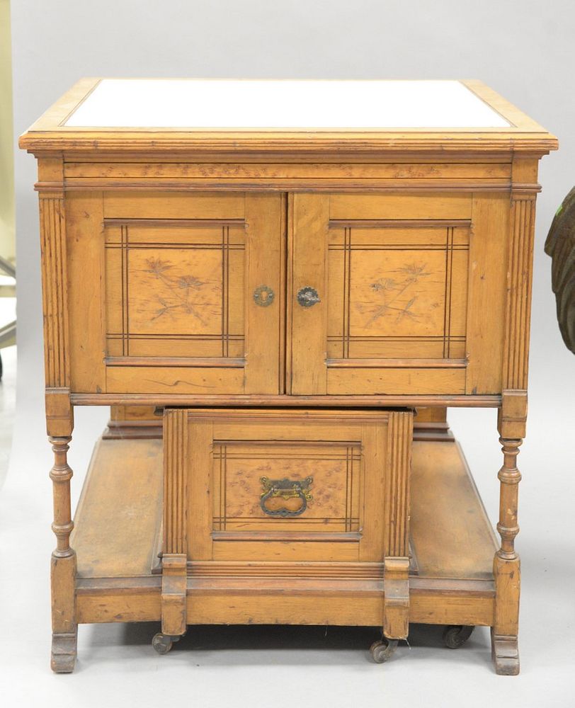 Appraisal: Victorian commode having inset marble top over two doors with