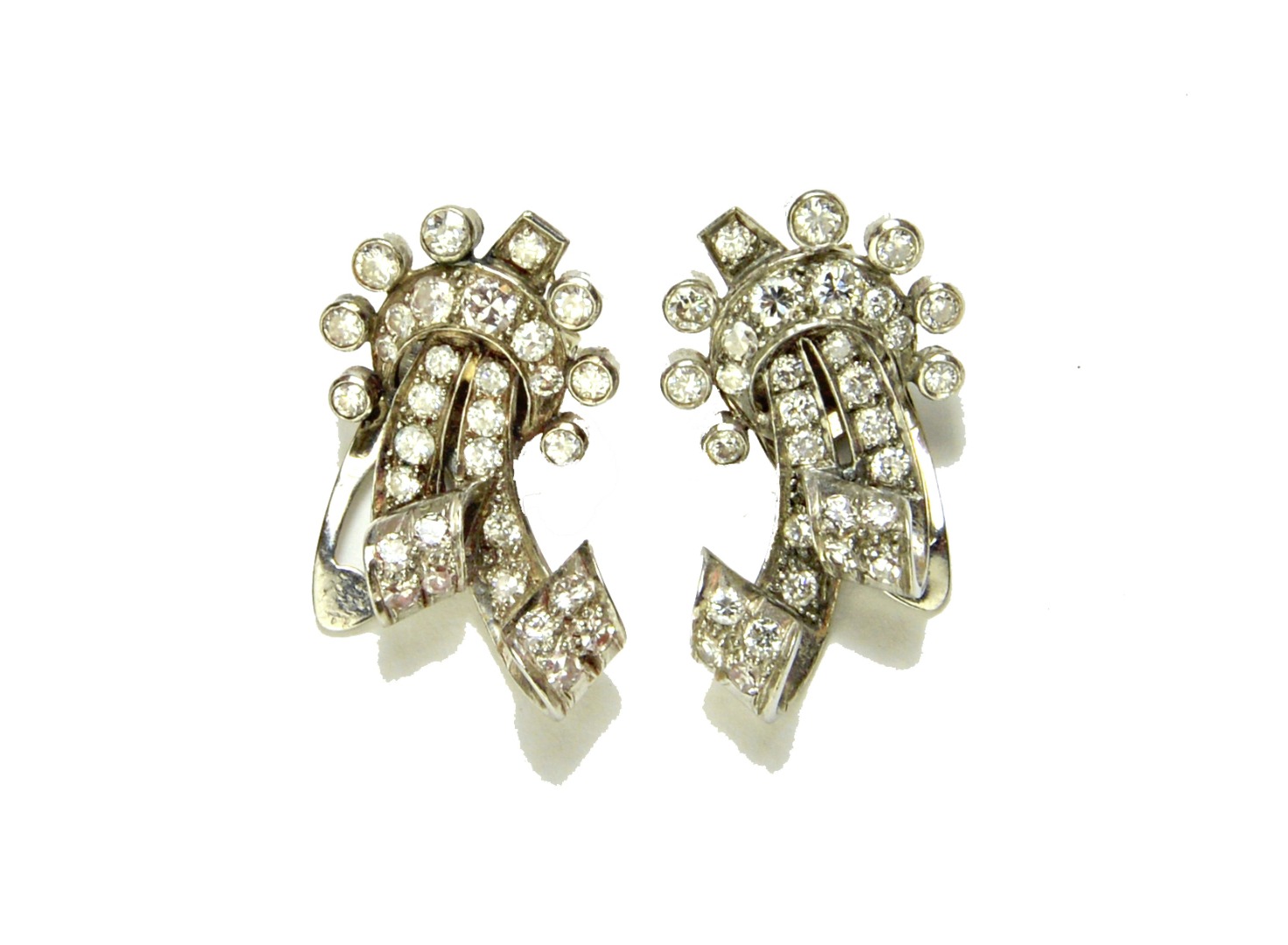 Appraisal: A pair of diamond set earclips each in a scrolling