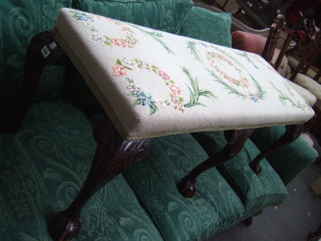 Appraisal: A long dressing stool with tapestry seat on mahogany acanthus