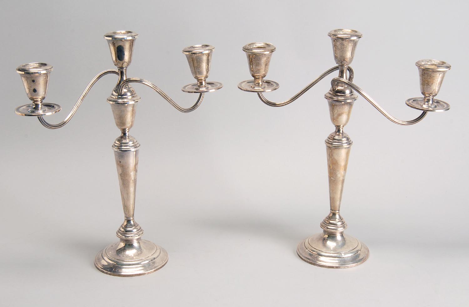 Appraisal: PAIR OF STERLING SILVER WEIGHTED CANDELABRA With three socles Height