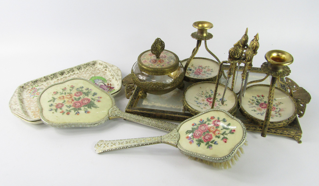 Appraisal: A 's brass and embroidered dressing table set and a