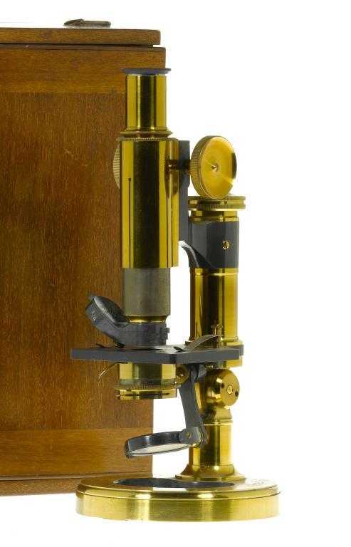 Appraisal: AN ENGLISH BRASS COMPOUND MICROSCOPE BY ROSS the substantial circular