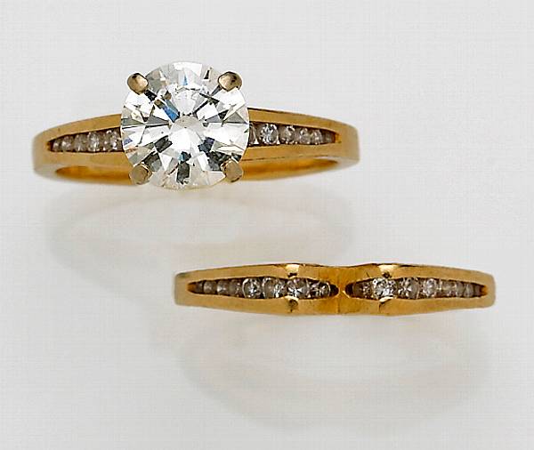 Appraisal: A diamond and fourteen karat gold solitaire ring and band