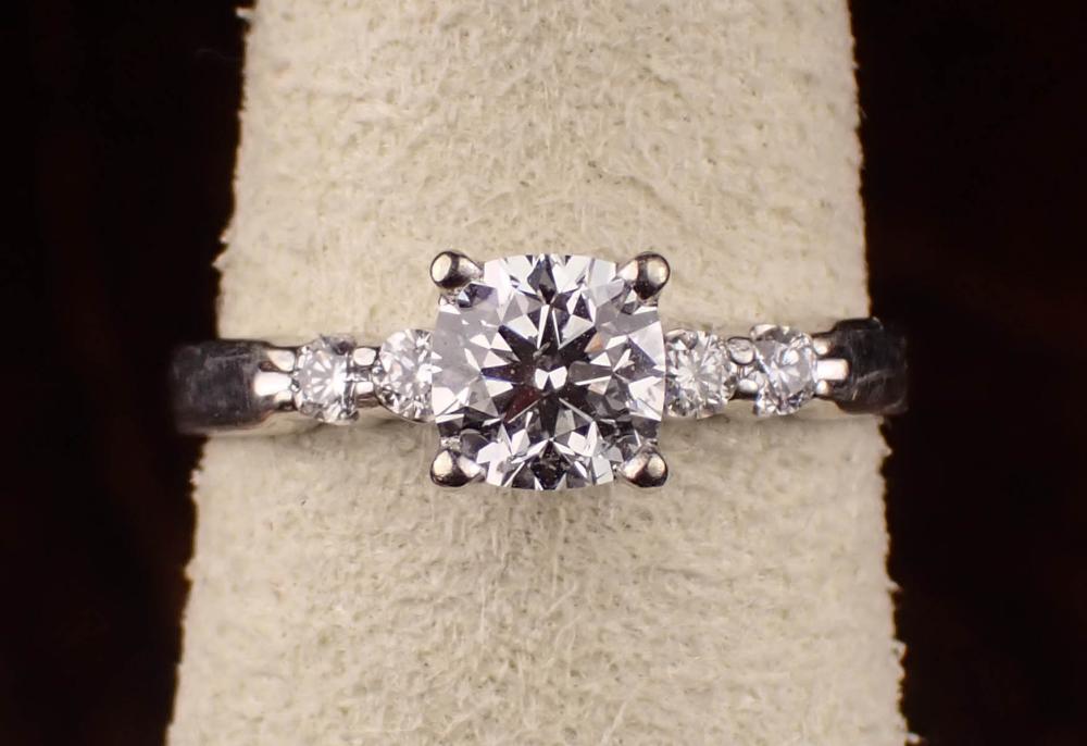 Appraisal: DIAMOND AND FOURTEEN KARAT WHITE GOLD RING with two round-cut