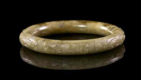 Appraisal: An Archaistic Double Dragon Yellow Jade Bangle of tubular form