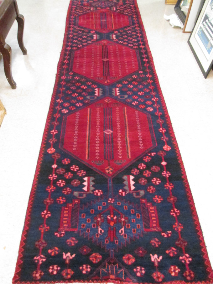 Appraisal: PERSIAN TRIBAL RUNNER hand knotted in a three octagonal medallion