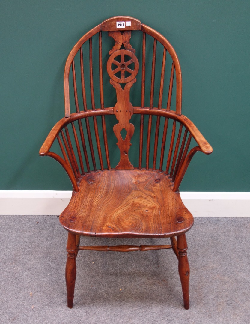 Appraisal: A George III yew and elm wheel back Windsor armchair