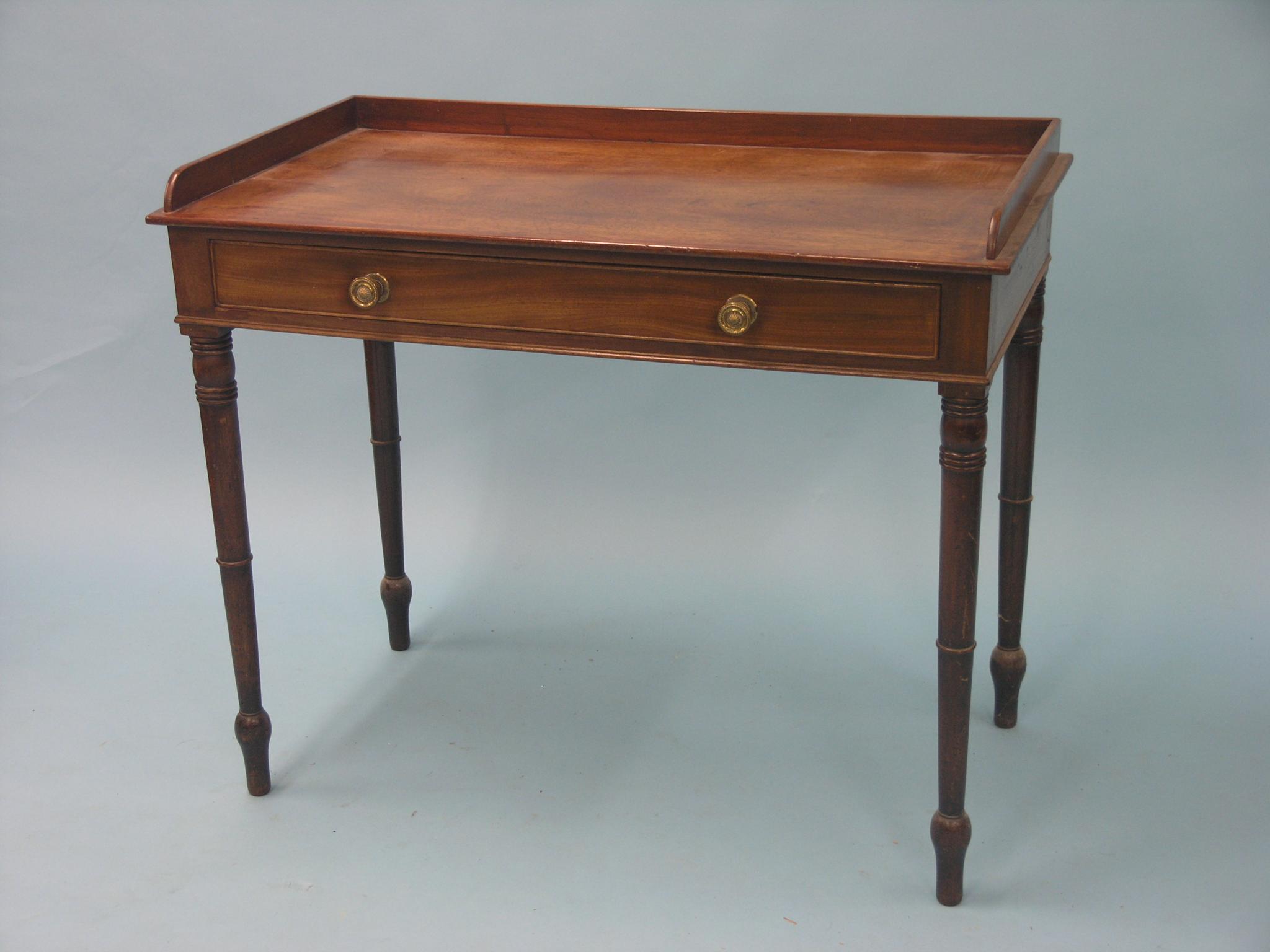 Appraisal: A Victorian mahogany writing table rectangular with low raised back