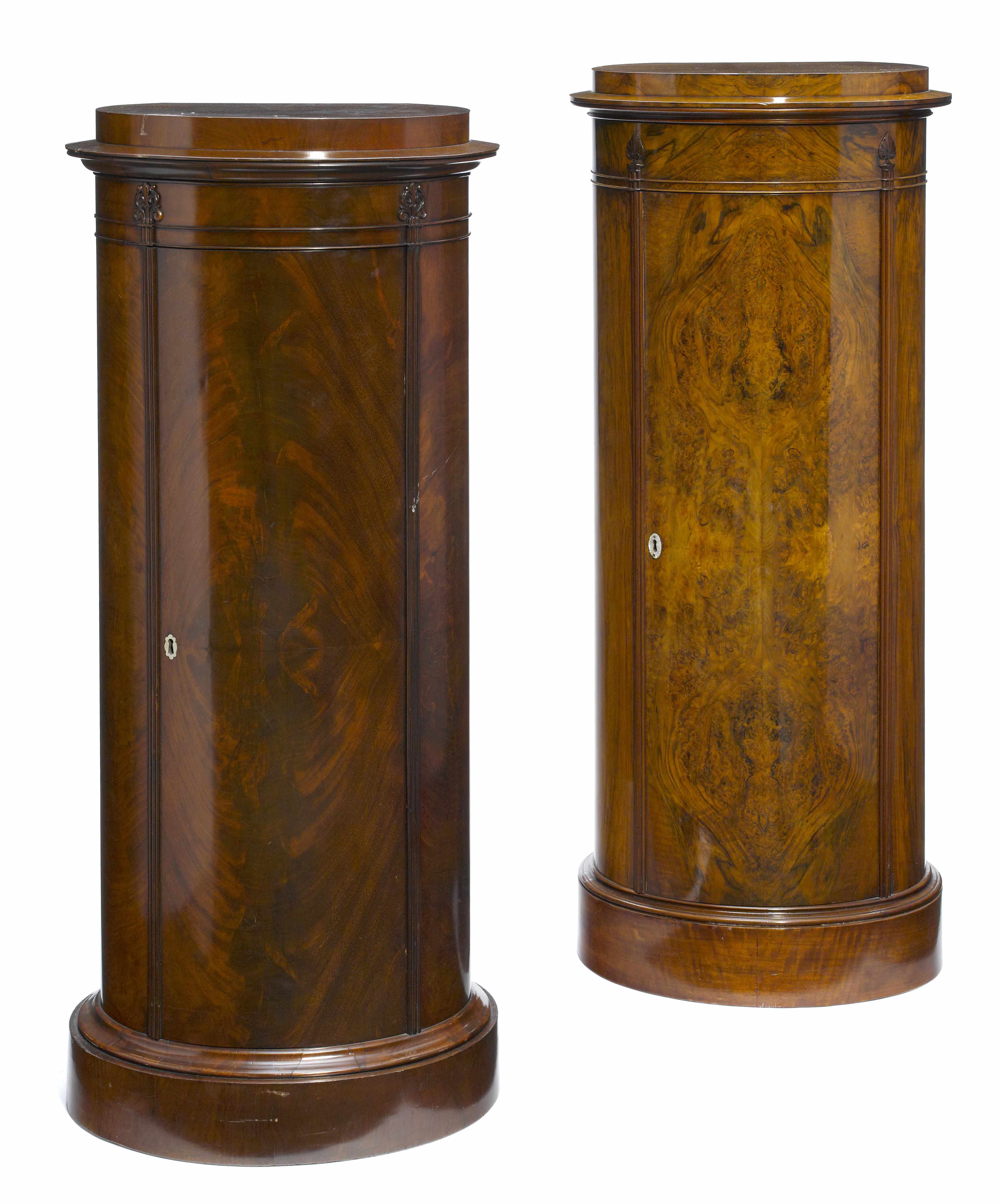 Appraisal: A pair of Empire style mahogany pedestal cupboards height in